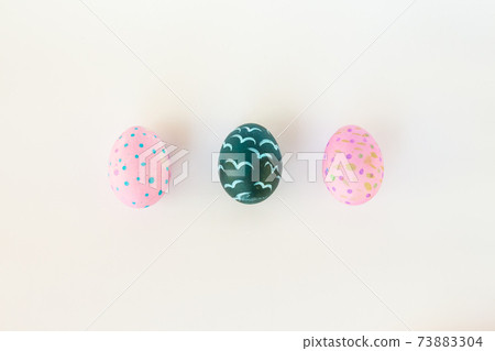 Set of colorful hand-painted Easter eggs. Bright children's drawings on Easter eggs top view on a white background. Happy Easter holiday and fun for children Set of colorful hand-painted Easter eggs. Bright children's drawings on Easter eggs top view on a white background. Happy Easter holiday and fun for children 73883304