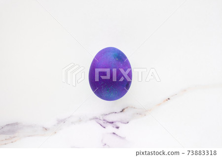 Minimal easter concept of purple eggs. Stylish Easter purple on white marble background. The flat lay fashionable easter. Happy easter card with copy space for text Minimal easter concept of purple eggs. Stylish Easter purple on white marble background. The flat lay fashionable easter. Happy easter card with copy space for text 73883318