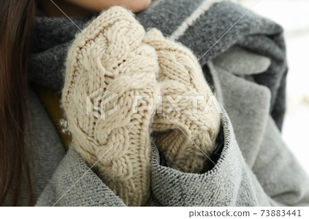 Woman in mittens outdoor in winter, close up 73883441
