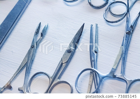 Old surgical metal medical devices on wooden table Old surgical metal medical devices on wooden table 73885145