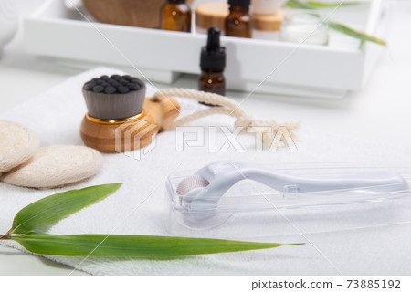 Micro needle meso derma Roller System, dry lymphatic massage wooden brush, loofah pads, and other elements for self face and body skin care. Home spa treatment. Natural beauty and zero-waste concept. Micro needle meso derma Roller System, dry lymphatic massage wooden brush, loofah pads, and other elements for self face and body skin care. Home spa treatment. Natural beauty and zero-waste concept. 73885192