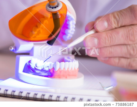 Dentist working teeth implant in medical lab Dentist working teeth implant in medical lab 73886187