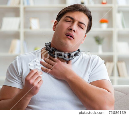Young man suffering from sore throat 73886189