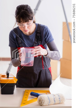 Woman preparing for wallpaper work 73886231