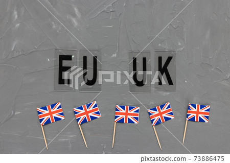 United Kingdom flags and text EU UK on gray background 73886475