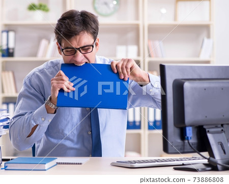 Tired businessman with too much paperwork Tired businessman with too much paperwork 73886808