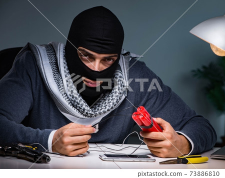Terrorist bomber preparing dynamite bomb 73886810