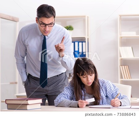 Male lecturer giving lecture to female student 73886843
