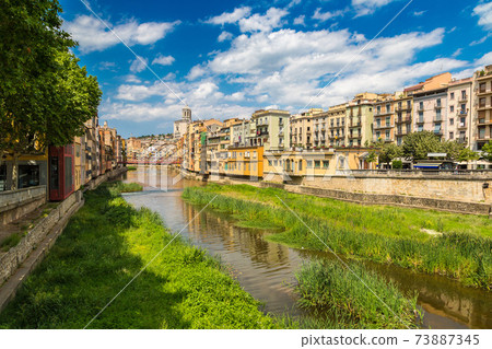 Colorful houses and Eiffel bridge in Girona 73887345