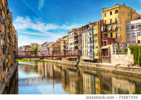Colorful houses and Eiffel bridge in Girona 73887350