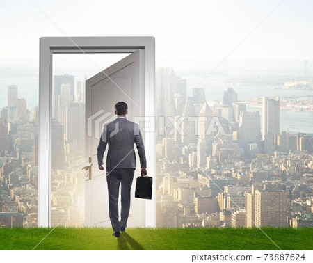 Businessman standing in front of door into future Businessman standing in front of door into future 73887624