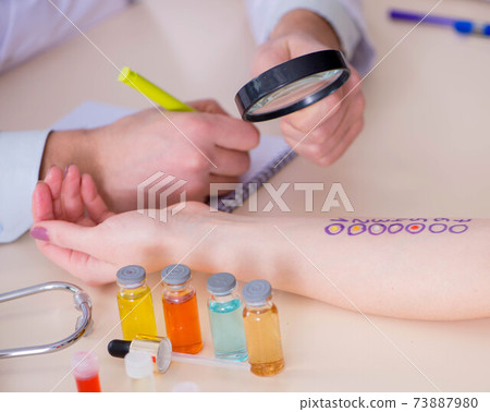 Doctor testing allergy reaction of patient in hospital 73887980