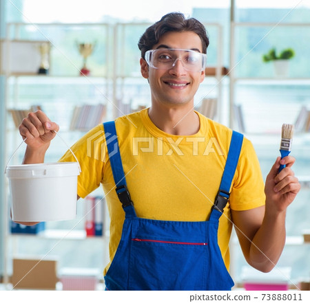 Painter with bucket of paint in workshop Painter with bucket of paint in workshop 73888011