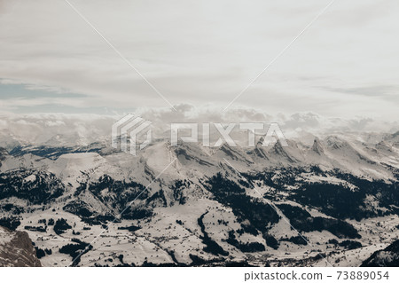 Snow covered swiss alps from above view of mountain Saentis 73889054