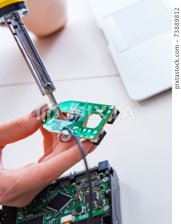 Engineer fixing broken computer hard drive 73889812
