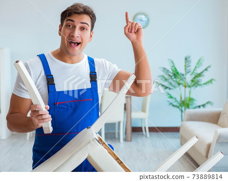 Repairman repairing broken chair at home 73889814
