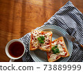 Tuna cheese toast and tea placed on the table 73889999