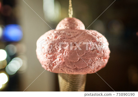 Icecream cone artificial hanging on display of cafe store Venchi in Milan, Italy. Ice cream decorative background. Icecream cone artificial hanging on display of cafe store Venchi in Milan, Italy. Ice cream decorative background. 73890190