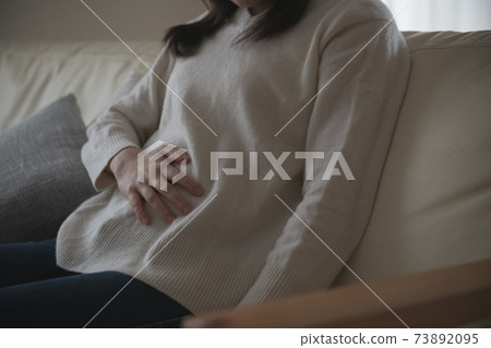 Image of a woman with abdominal pain and poor physical condition Image of a woman with abdominal pain and poor physical condition 73892095