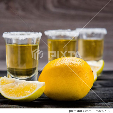 Tequila drink served in glasses with lime and salt Tequila drink served in glasses with lime and salt 73892329