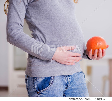 Pregnant woman touching her belly Pregnant woman touching her belly 73893769