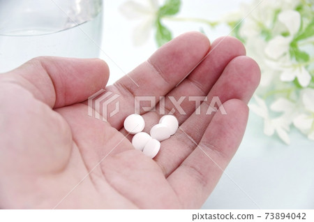 Palm and pills 73894042
