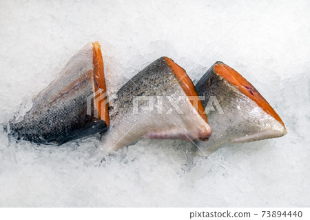 three pieces of pink salmon in ice three pieces of pink salmon in ice 73894440