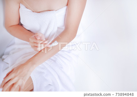 Woman applying cream,lotion on hand with white background, Beauty concept. Top view Woman applying cream,lotion on hand with white background, Beauty concept. Top view 73894848