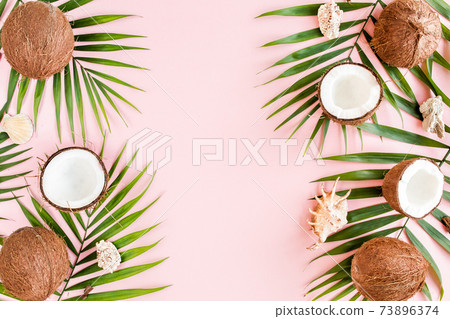 Pattern, frame borders with coconuts and tropical palm leaves on pink background. Tropical abstract background. Flat lay, top view. 73896374
