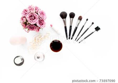 Makeup tools. Home office workspace. Female fashion, makeup brushes, cup of coffee on white background. Flat composition. Top view. Flat lay. 73897090