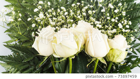 White roses bouquet as gift on a holiday on gray 73897459