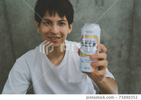 Young people drinking canned beer 73898352
