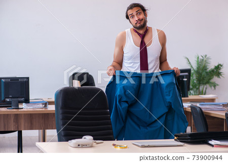 Young male employee coming to work straight from bed 73900944