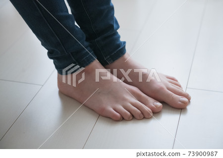 Image of a woman with cold feet and feet of barefoot women Image of a woman with cold feet and feet of barefoot women 73900987