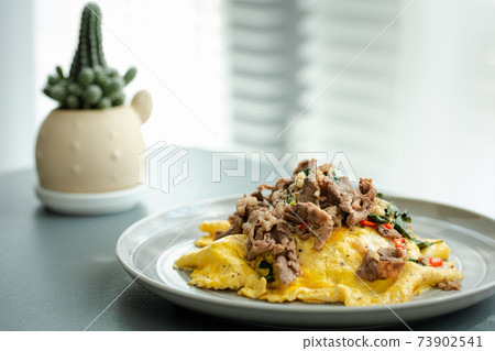 stir fried thai styled basil with beef and omelet topped on rice 73902541