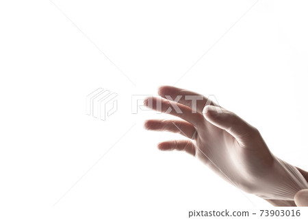 Human holding Variation of Latex Glove, Rubber glove manufacturing, human hand is wearing a medical glove. Coronavirus 73903016