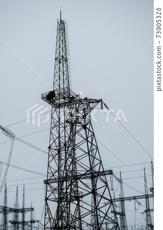 High-voltage power lines. Vertical photo. Transmission of electricity. High-voltage power lines. Vertical photo. Transmission of electricity. 73905328