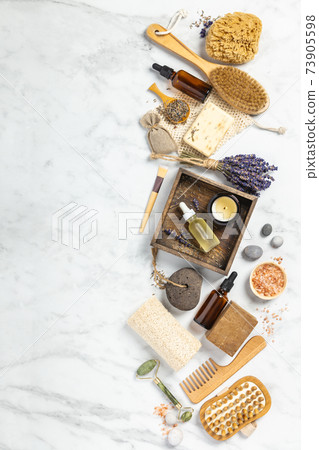 Flat lay composition with lavender flowers and natural cosmetic products on white marble background Flat lay composition with lavender flowers and natural cosmetic products on white marble background 73905598