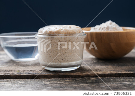 Heaping jar of sourdough starter yeas Heaping jar of sourdough starter yeas 73906321
