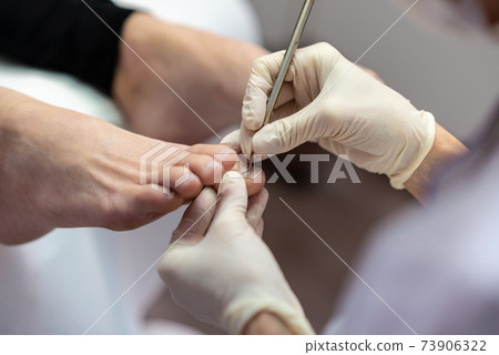 Closeup view of beautician making pedicure Closeup view of beautician making pedicure 73906322