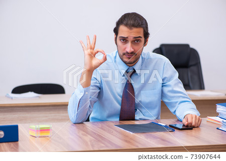 Young male employee working in the office 73907644