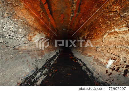 Large sewage tunnel with filth flowing out 73907997