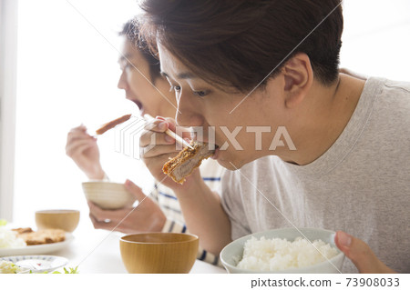 Eating appetite young people eating meat Eating appetite young people eating meat 73908033