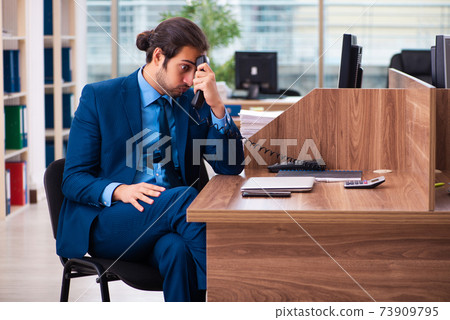 Young male employee working in the office Young male employee working in the office 73909795