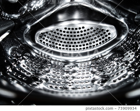 Washing machine drum closeup. Washing machine drum closeup. 73909934