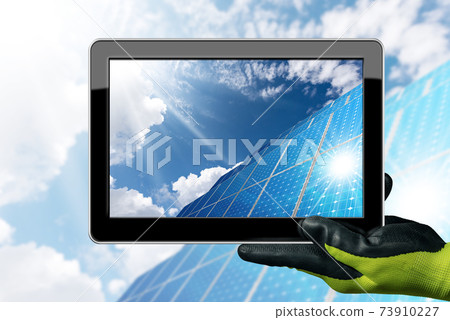 Gloved Hand Holding a Digital Tablet Computer with many Solar Panels Gloved Hand Holding a Digital Tablet Computer with many Solar Panels 73910227