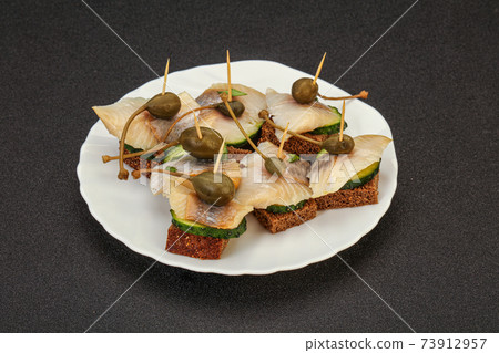 Herring fillet canape with caperberry 73912957