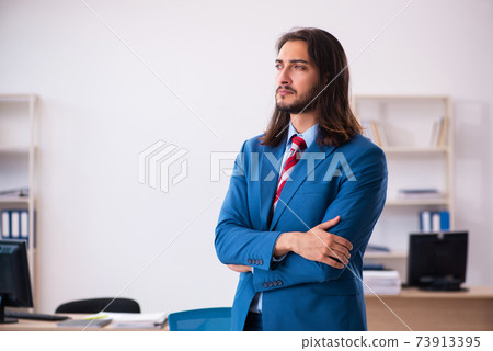 Young male employee working at workplace Young male employee working at workplace 73913395