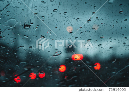 Water droplets on the glass in the evening rain blur Water droplets on the glass in the evening rain blur 73914003