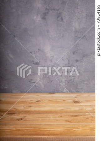 wooden desk table or shelf near grey concrete wall wooden desk table or shelf near grey concrete wall 73914165
